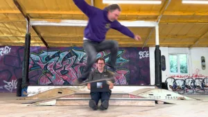 Wight Computers Managing Director Andrew Nordbruch stays calm under pressure as John Cattle ollies a skateboard over him, laptop and all, to celebrate a £1,000 donation to John Cattle’s Skate Club C.I.C.